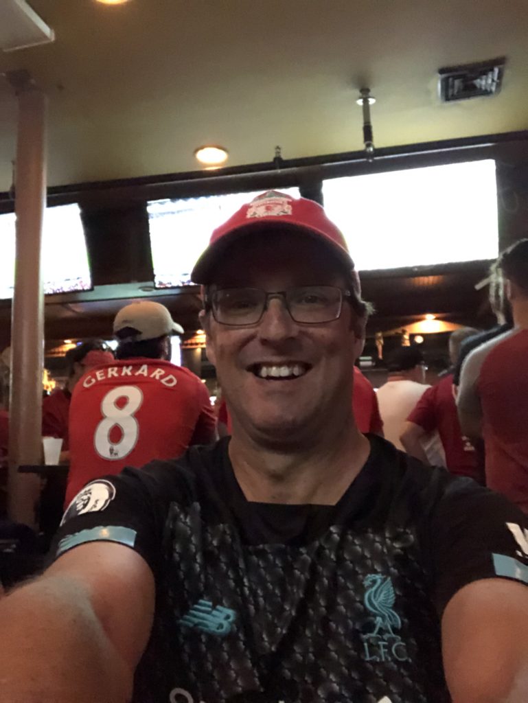 Selfie of a man in Liverpool kit at a bar