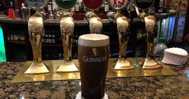 Beer on bar in front of taps - Guinness