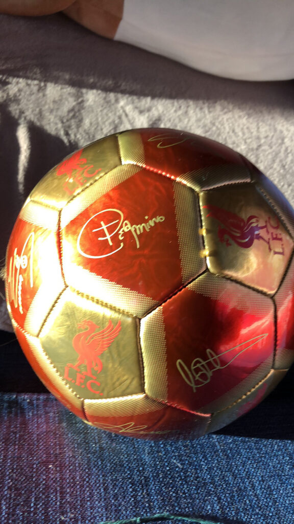 Signed soccer ball in gold and red